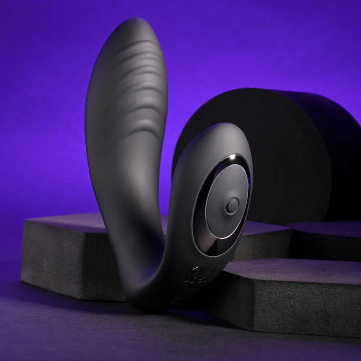 Black Play Time vibrator standing upright, ribbed arm and round control in view