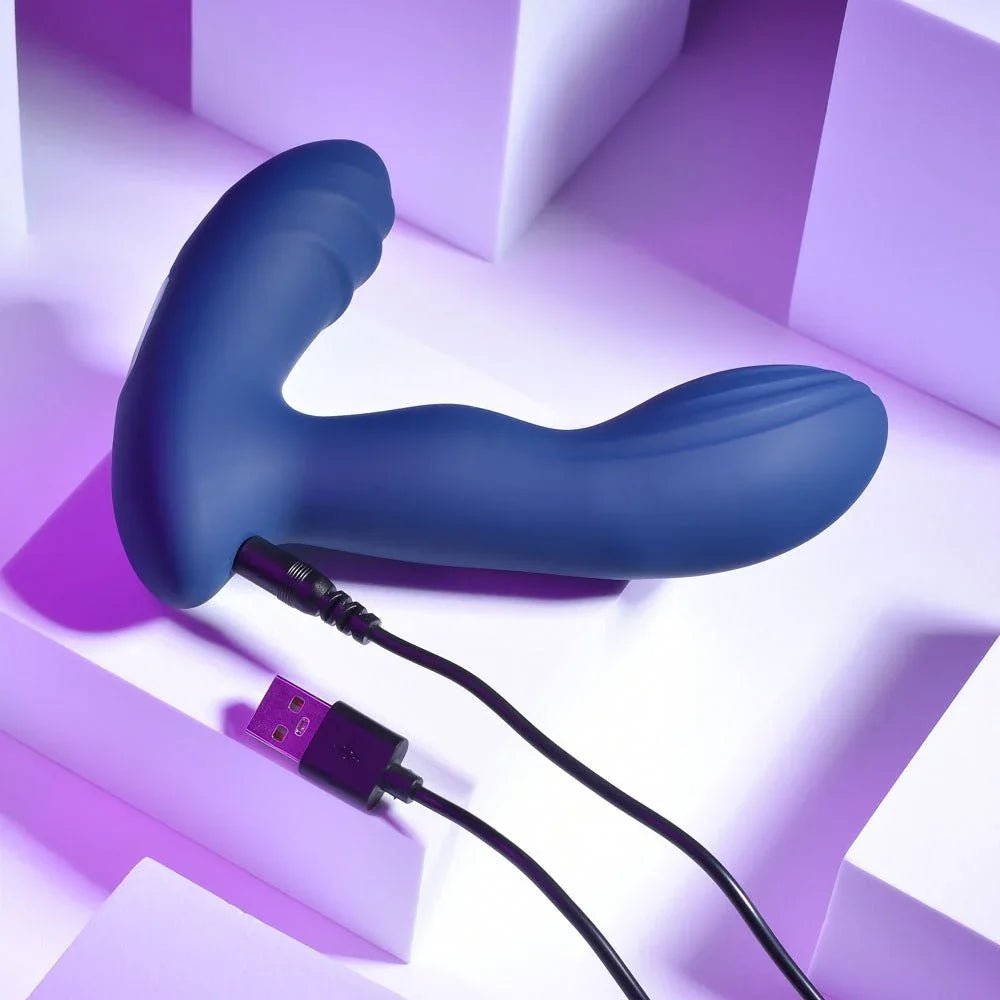 Blue Pleasure Pleaser prostate massager with its USB charging cable attached