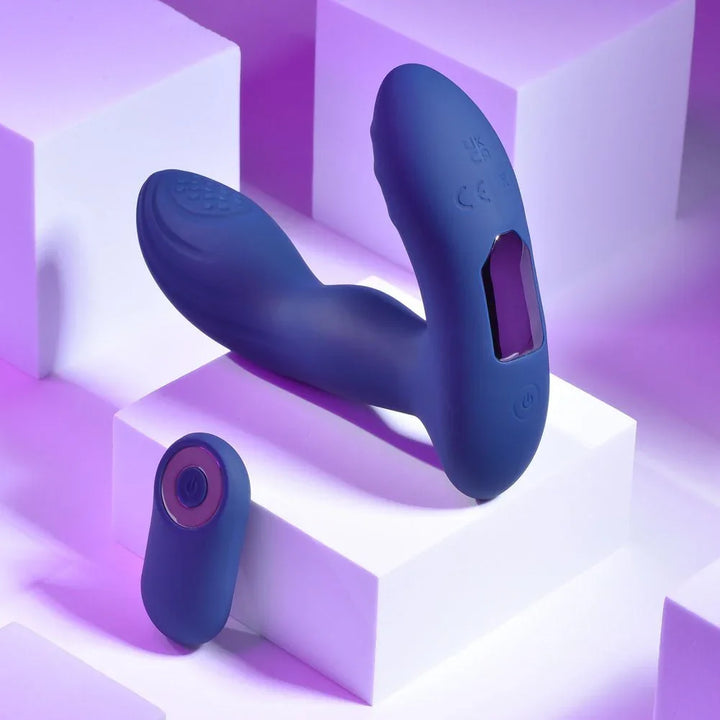 Blue Pleasure Pleaser prostate massager upright with its round wireless remote below
