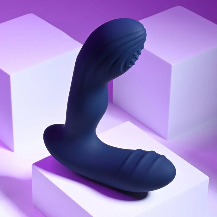 Blue Pleasure Pleaser angled to show the curved shaft and textured perineal arm