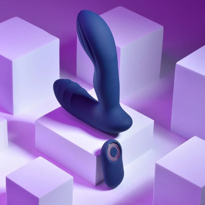 Blue Pleasure Pleaser propped on white blocks with the remote resting at its base