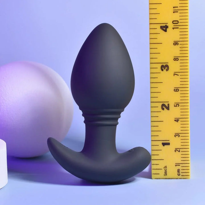 Black Plug & Play butt plug standing beside a ruler at about 4 inches