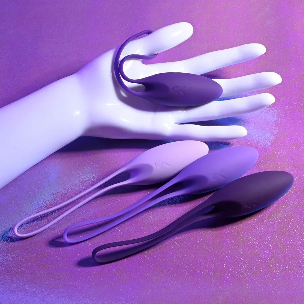 Put In Work kegel balls draped over a white display hand to show their scale