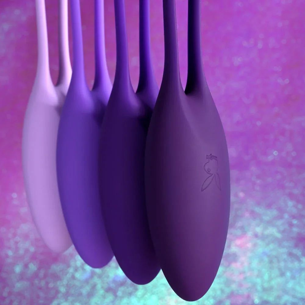 Close-up of the four purple kegel balls with the Playboy bunny moulded into the silicone