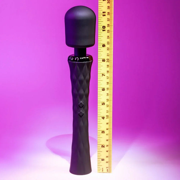 Black Royal massage wand upright against a ruler at about 11.5 inches