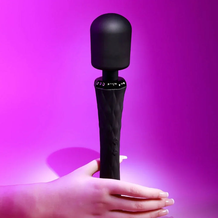 Black Royal massage wand standing upright with a hand resting at its base