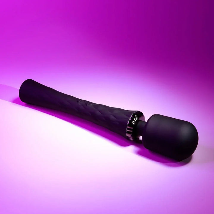Black Royal massage wand lying on the diagonal, soft head to the right