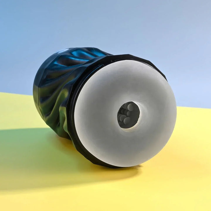 Solo stroker on its side with the clear textured opening facing the camera