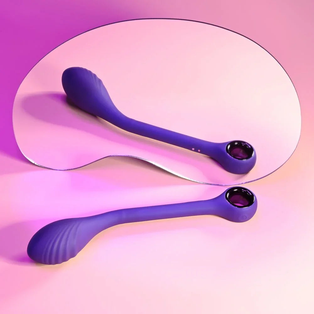 Purple Spot On vibrator lying on a mirrored oval, reflected full length