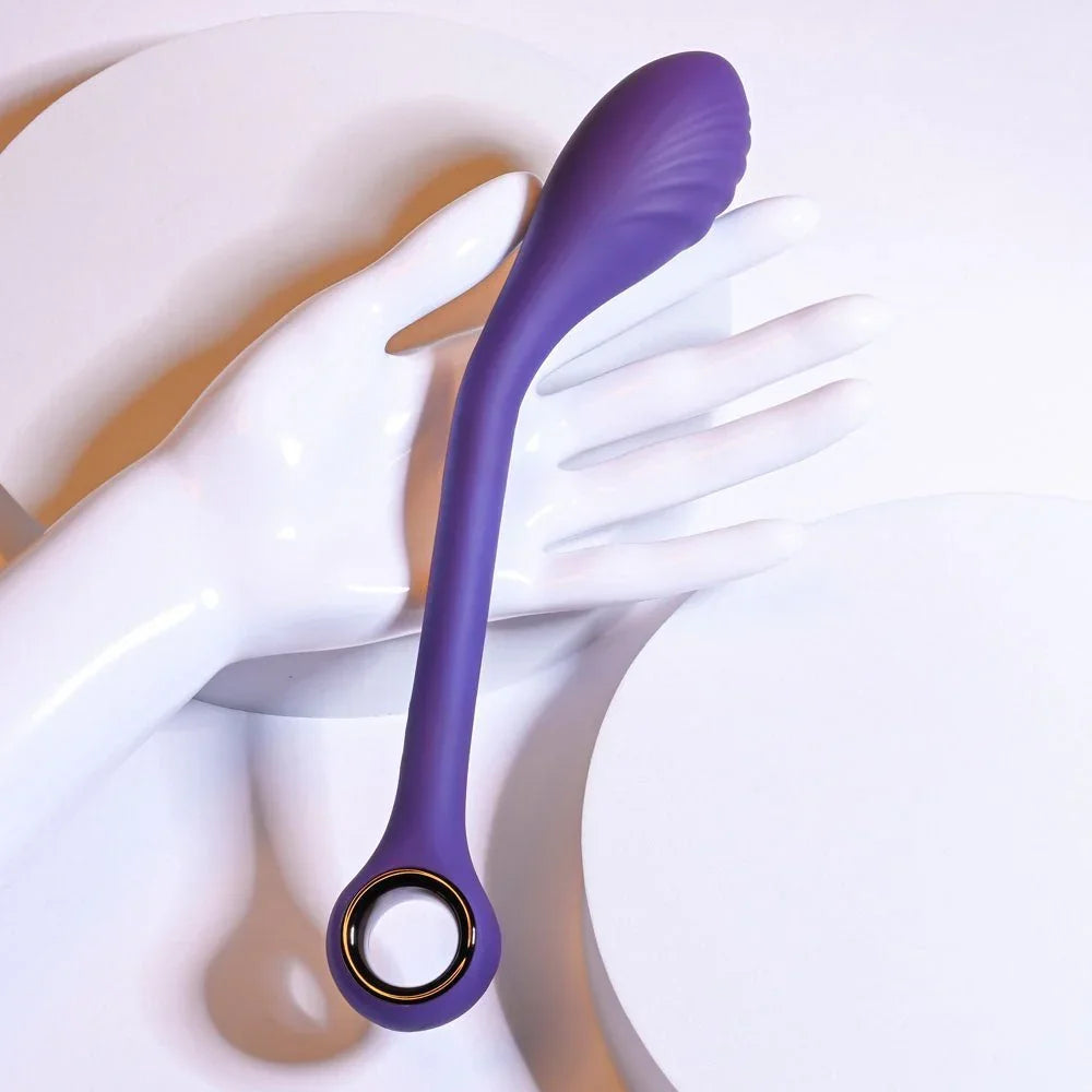 Purple Spot On vibrator resting on a white display hand, ring handle at the base