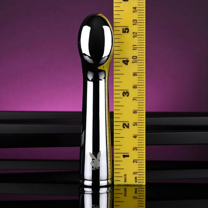 Chrome Swoon vibrator standing beside a ruler at about 5.5 inches