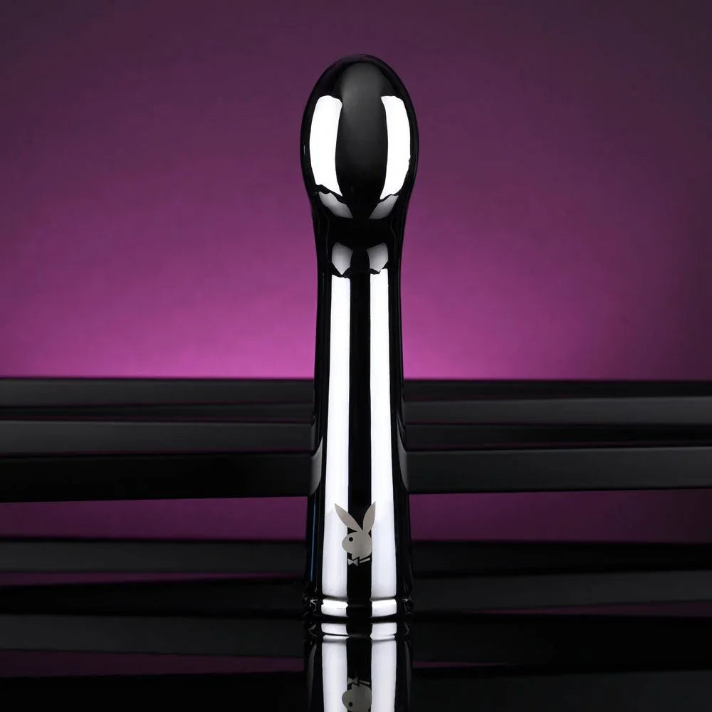 Chrome Swoon vibrator upright with the rounded tip turned toward the camera