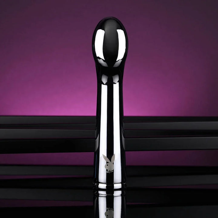 Chrome Swoon vibrator upright with the rounded tip turned toward the camera