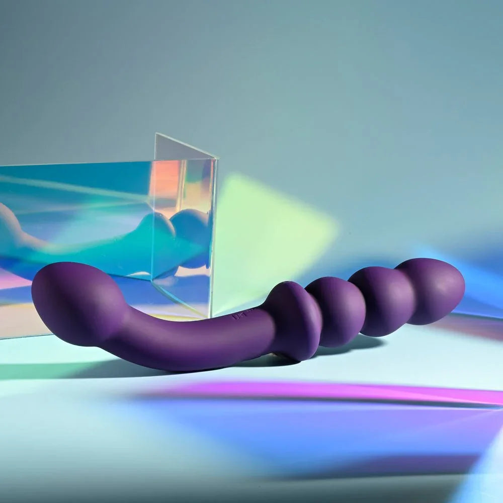 The Seeker in purple on an iridescent surface, both ends of the shaft in view