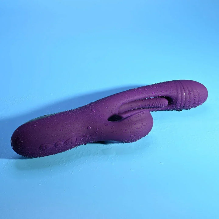 Close-up of the Thrill's nubbed purple silicone shaft lying flat