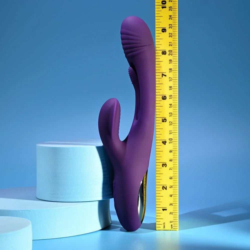Purple Thrill rabbit vibrator standing against a ruler at about 9.5 inches