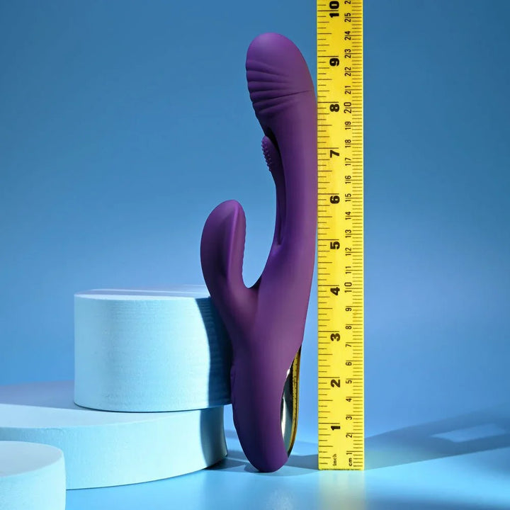 Purple Thrill rabbit vibrator standing against a ruler at about 9.5 inches