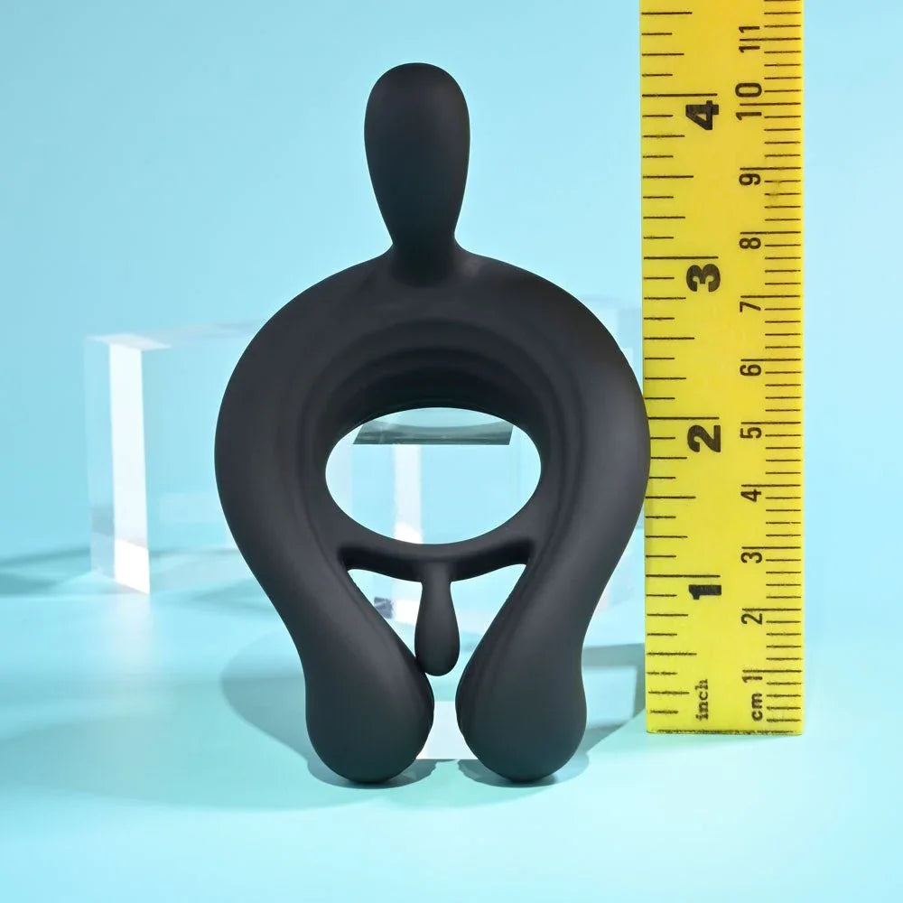 Black Triple Play cock ring measured against a ruler at about 3.5 inches tall