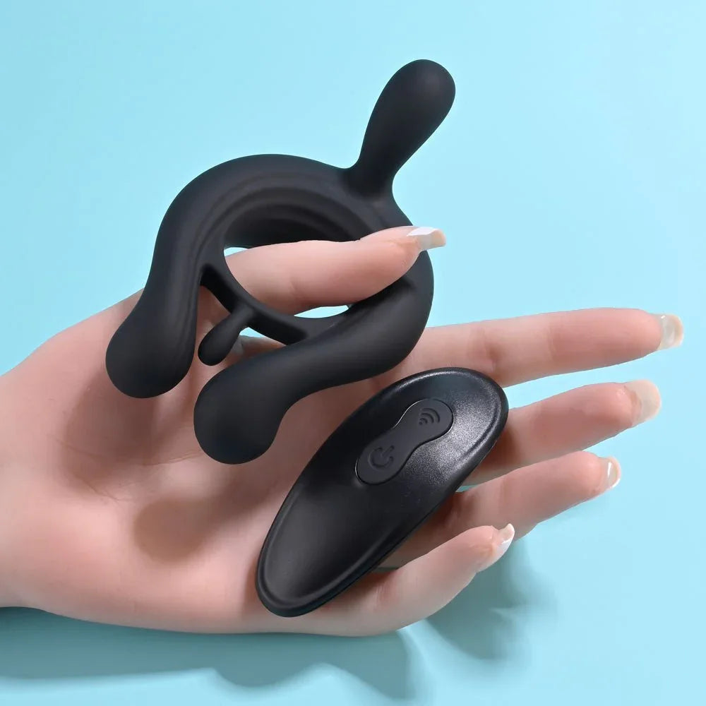 Triple Play cock ring and its remote held in a hand to show their size