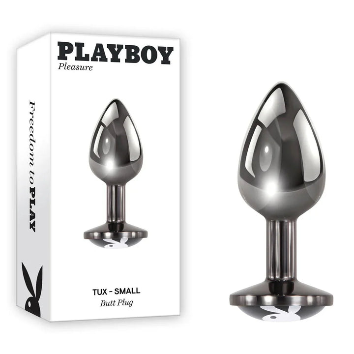Playboy Pleasure TUX Small butt plug in chrome beside its white Playboy retail box