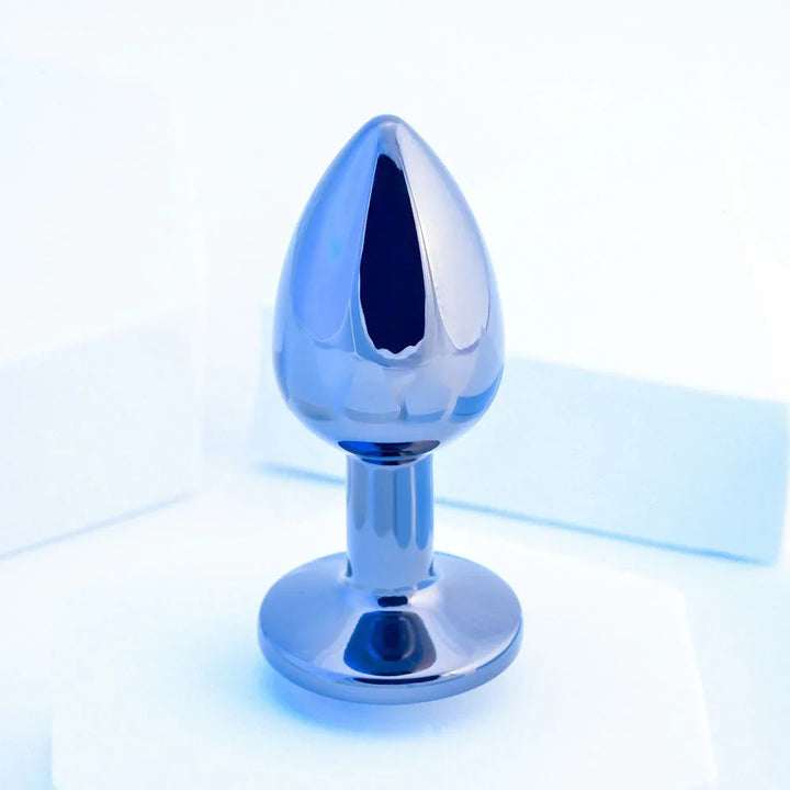Chrome TUX butt plug standing upright, tapered bulb above a flared round base