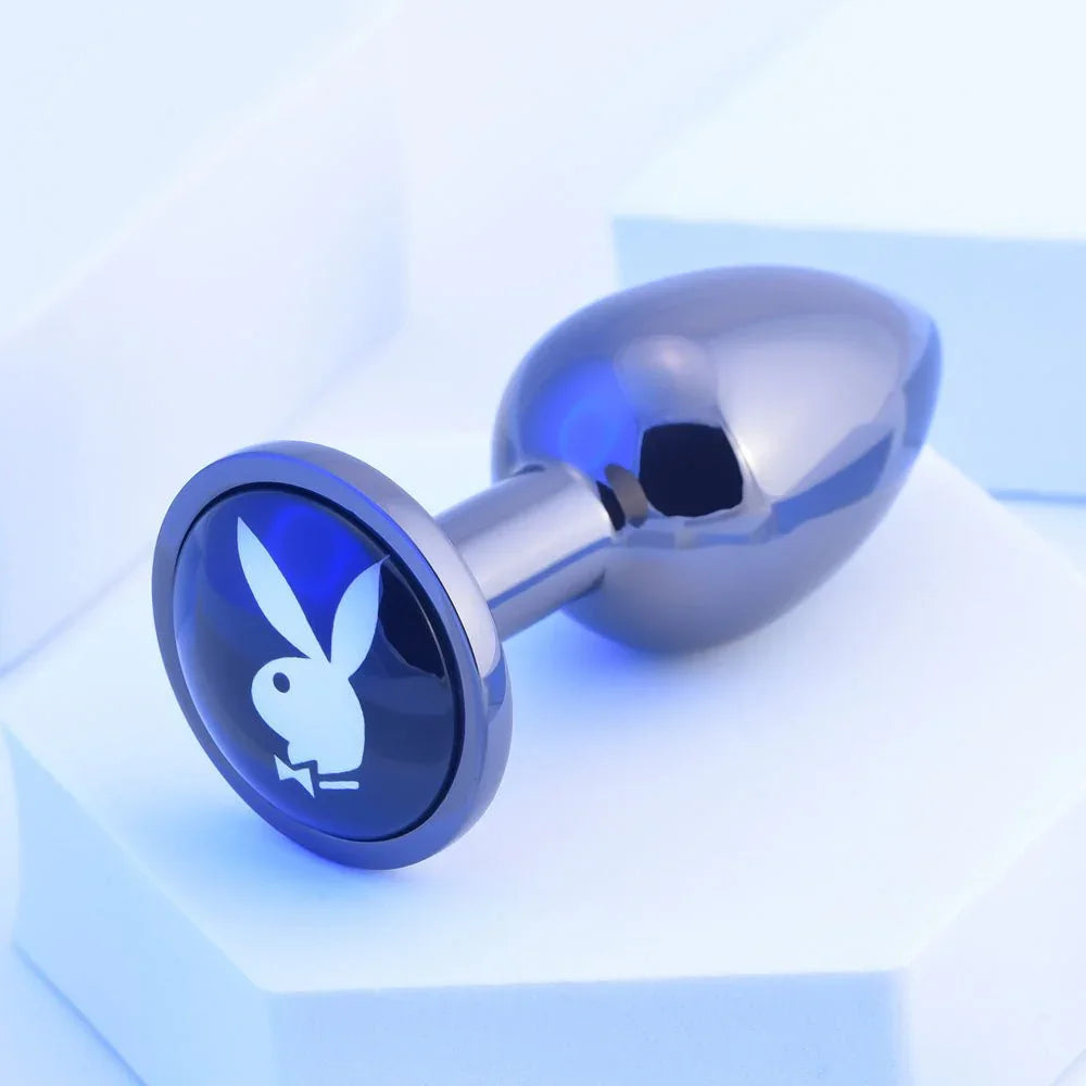Chrome TUX butt plug angled to show the blue Playboy bunny medallion on its base