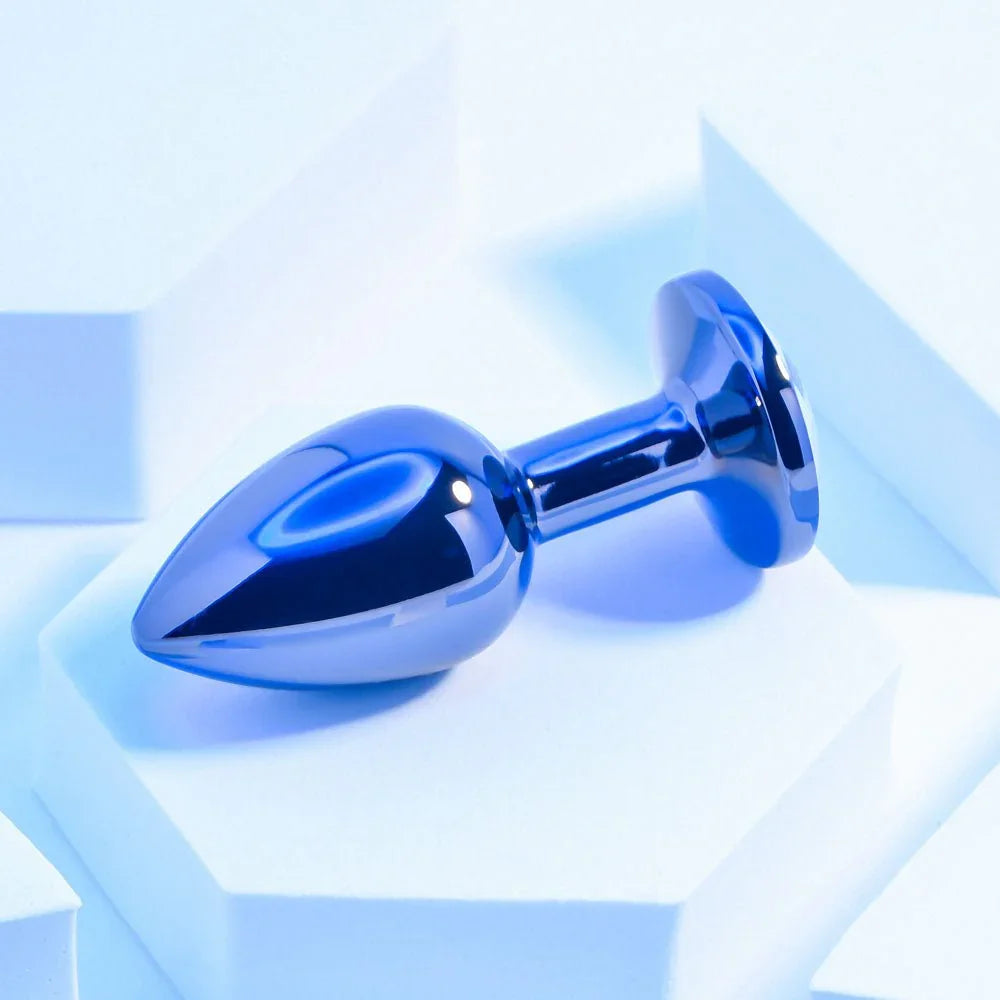 Chrome TUX butt plug lying on its side, showing the bulb and narrow neck