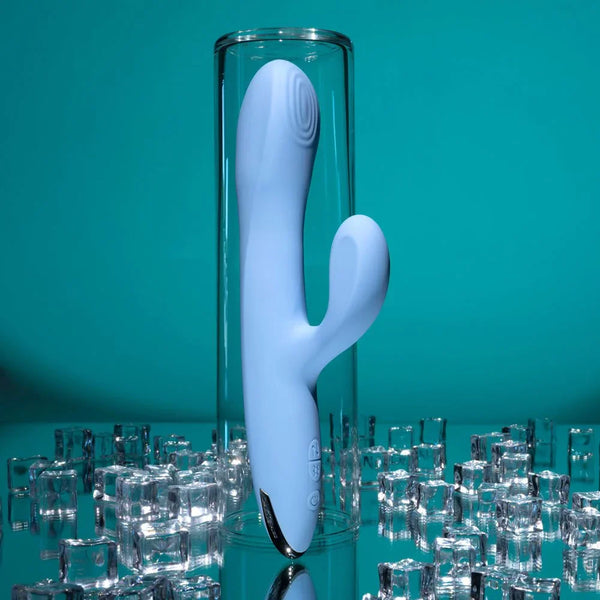 Light blue Up And Away rabbit vibrator standing in a glass tube on crushed ice