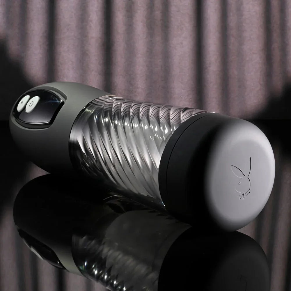 Whirlwind stroker on its side showing the spiral-ribbed clear sleeve and buttons