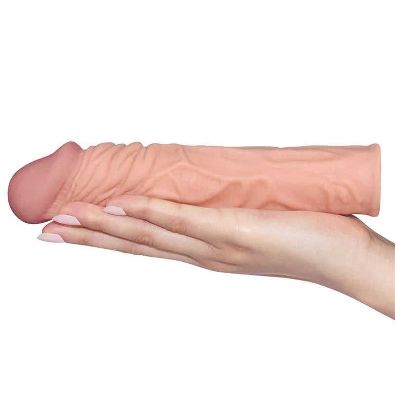 Pleasure X-Tender 2 inch sleeve resting across a flat hand, showing its length and girth