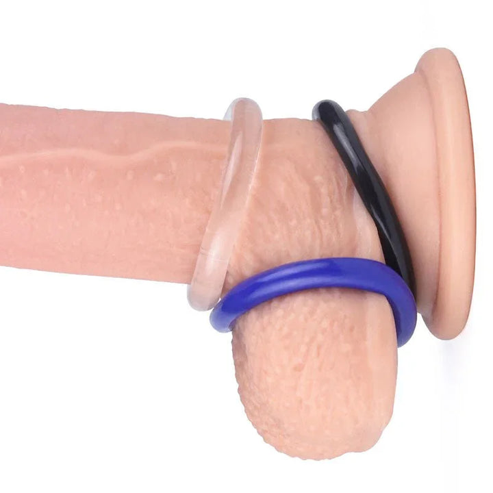 All three donut rings worn together on a realistic shaft, plus a thin black ring