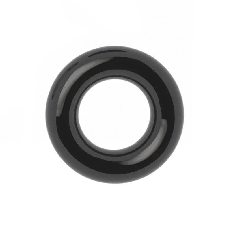 Black donut cock ring on white, showing the rounded doughnut profile