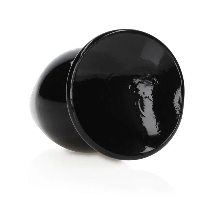 REALROCK 11.5 cm Anal Plug in Black, tipped over so the flared base faces the camera