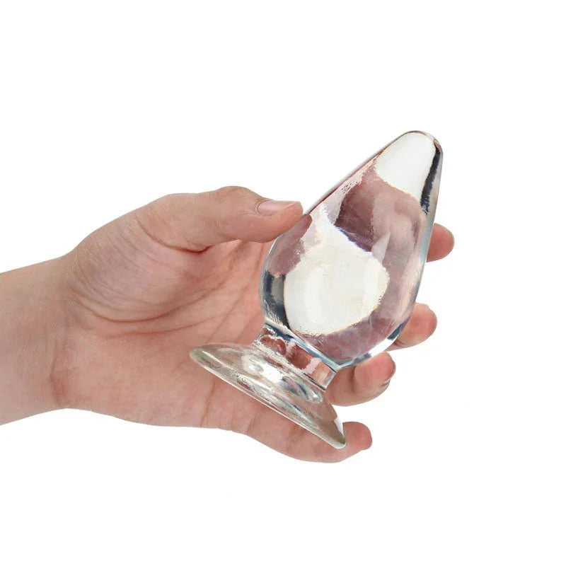 REALROCK 11.5 cm Anal Plug in Clear, held in one hand to show the plug's width