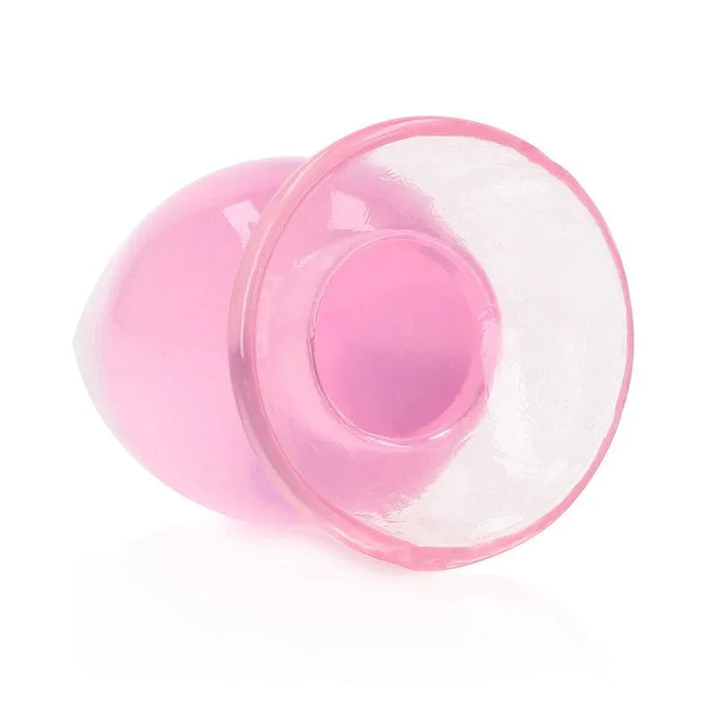 REALROCK 11.5 cm Anal Plug in Pink, tipped over so the flared base faces the camera