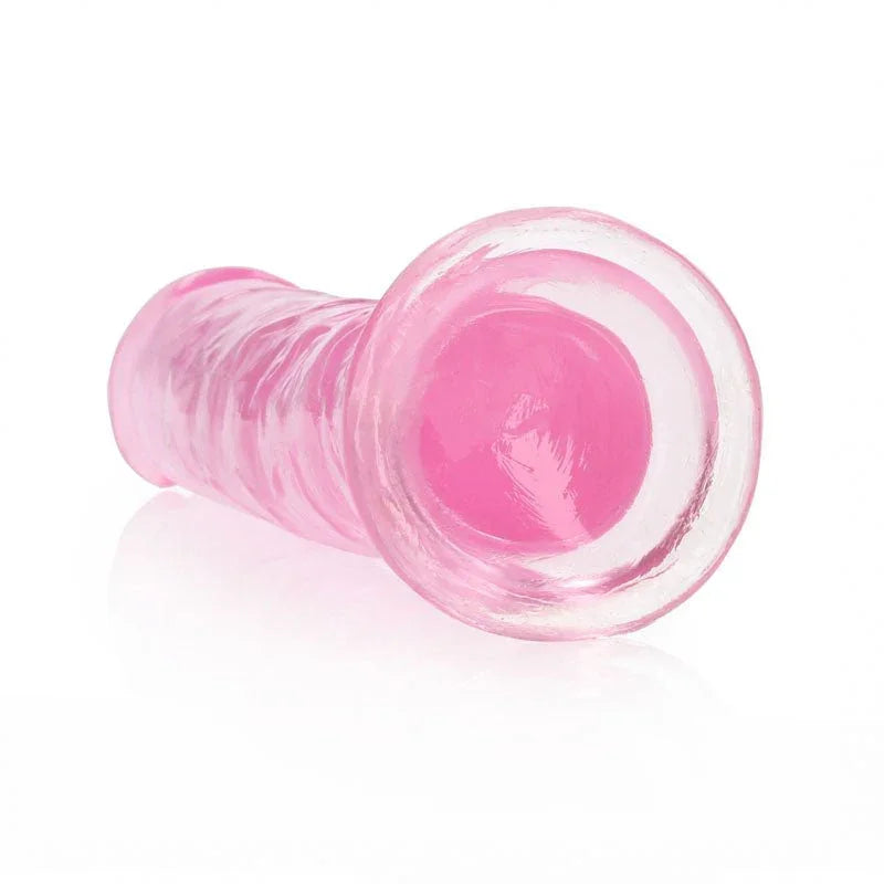 REALROCK 18 cm Straight Dildo in Pink, lying down with the suction base facing the camera