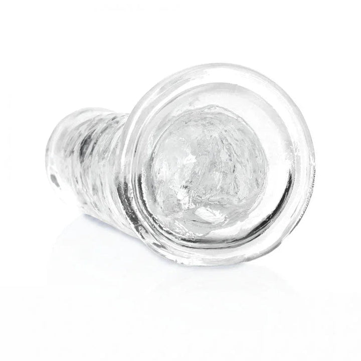 REALROCK 18 cm Straight Dildo in Clear, lying down with the suction base facing the camera