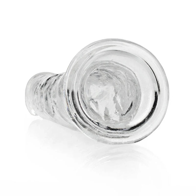 REALROCK 25 cm Straight Dildo in Clear, lying down with the suction base facing the camera