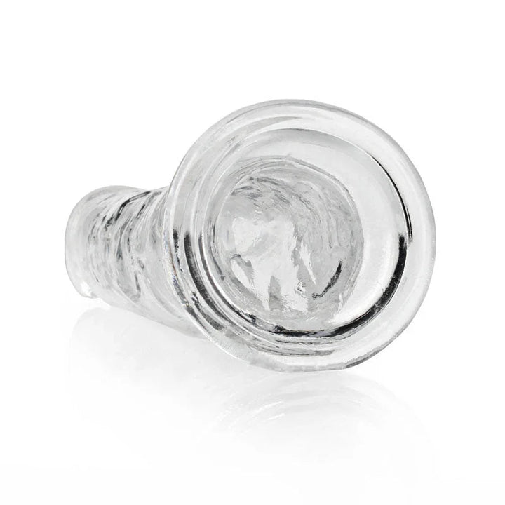 REALROCK 25 cm Straight Dildo in Clear, lying down with the suction base facing the camera