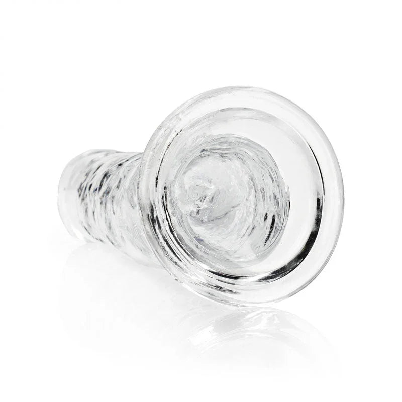 REALROCK 31 cm Straight Dildo in Clear, lying down with the suction base facing the camera