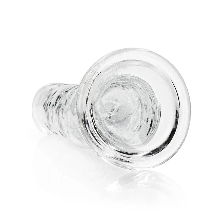 REALROCK 31 cm Straight Dildo in Clear, lying down with the suction base facing the camera