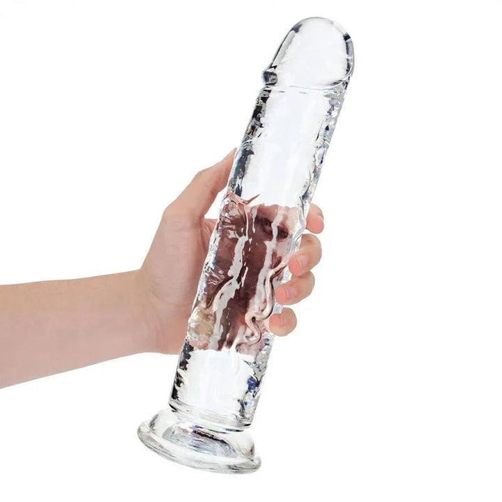 REALROCK 31 cm Straight Dildo in Clear, held in one hand to show its length