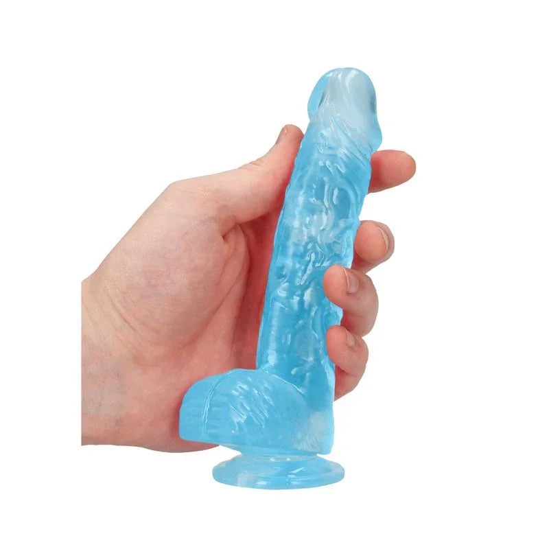 REALROCK 15.2 cm Realistic Dildo with Balls in Blue, held in one hand to show its girth