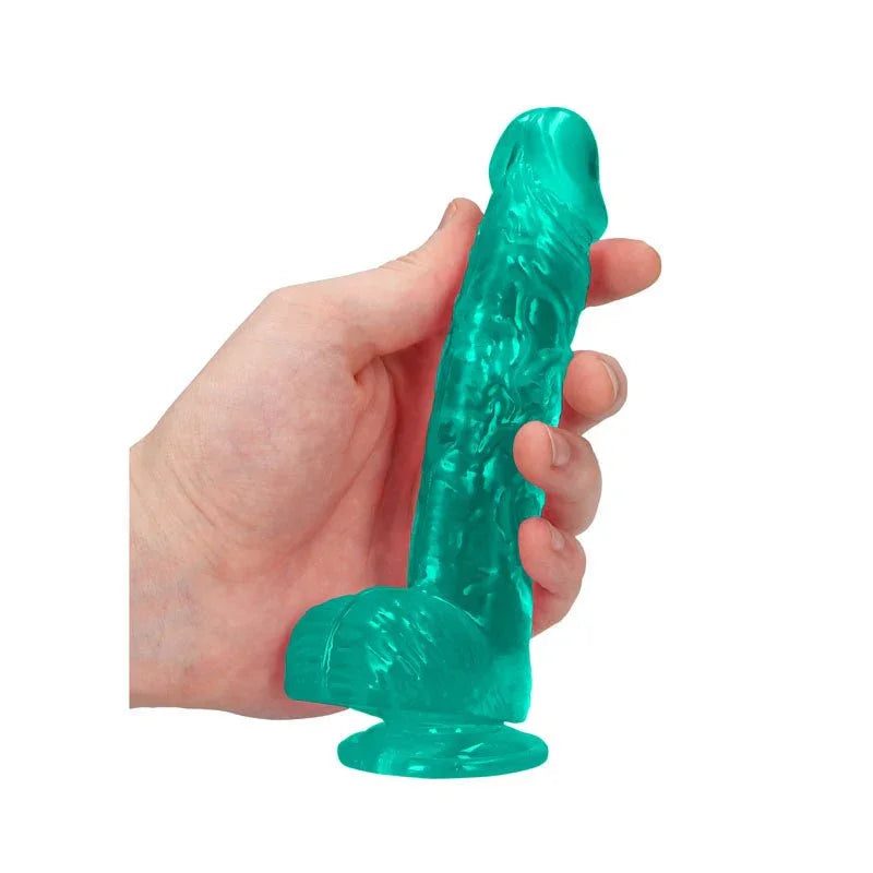 REALROCK 15.2 cm Realistic Dildo with Balls in Turquoise, held in one hand to show its girth