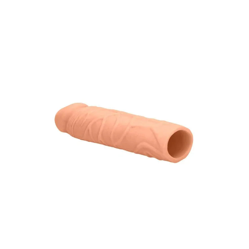 REALROCK 17.8 cm Penis Extender Sleeve in Flesh, lying at an angle showing the hollow cavity