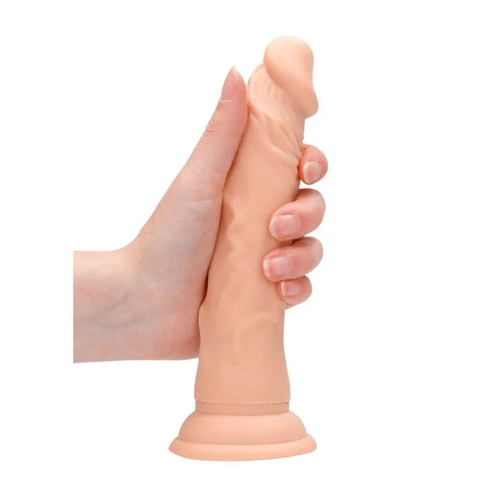 REALROCK 17.8 cm Realistic Dildo in Flesh, held in one hand to show its girth