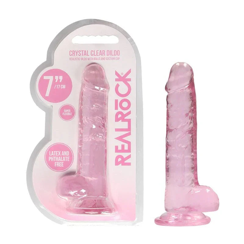 REALROCK 17.8 cm Realistic Dildo with Balls in Pink, blister pack beside the jelly-clear dildo