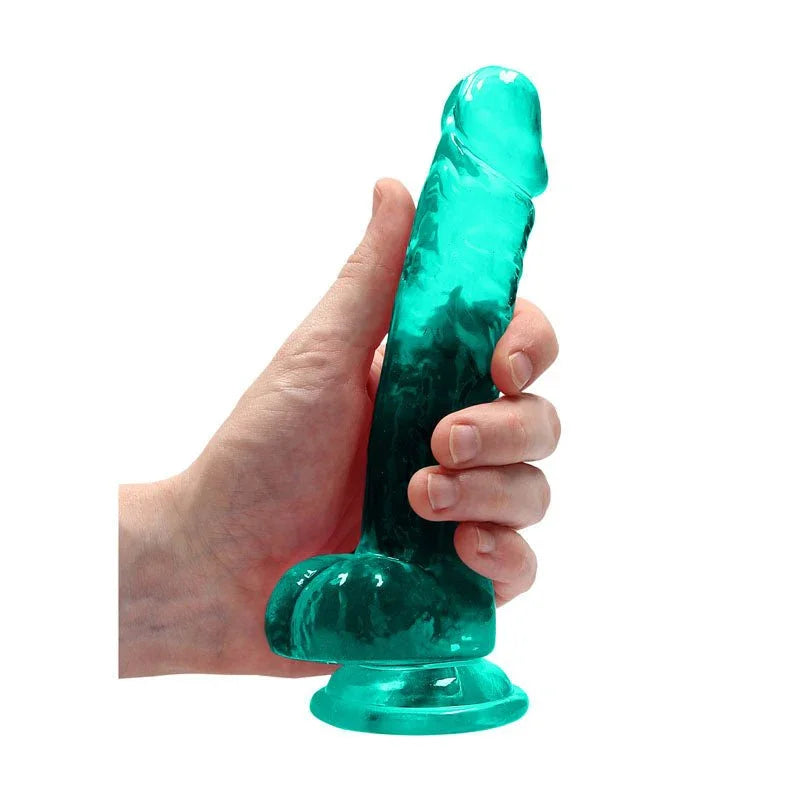 REALROCK 17.8 cm Realistic Dildo with Balls in Turquoise, held in one hand to show its girth