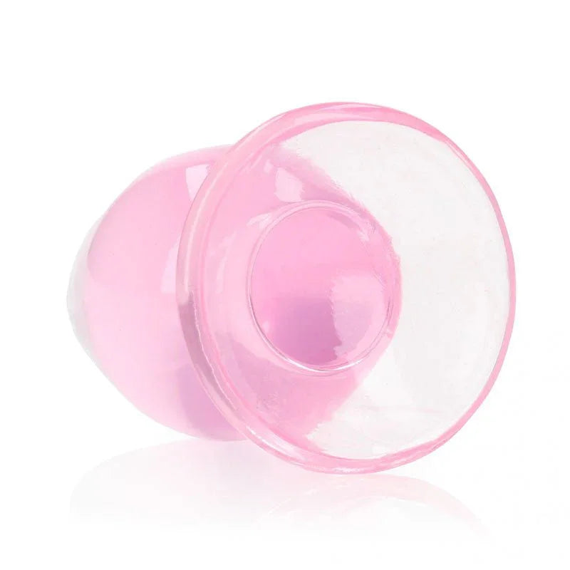 REALROCK 9 cm Anal Plug in Pink, tipped over so the flared base faces the camera