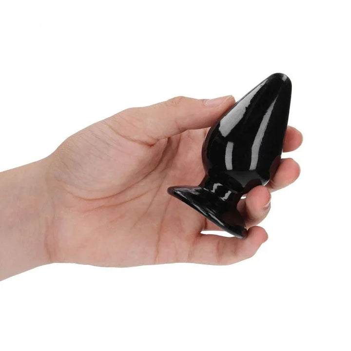 REALROCK 9 cm Anal Plug in Black, held in one hand to show the plug's width